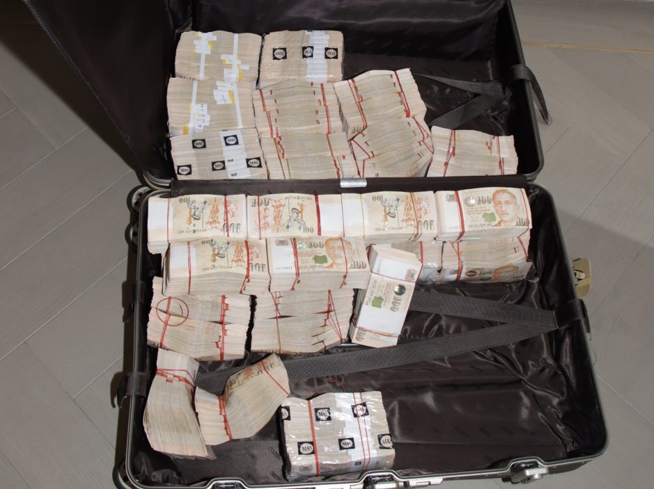 Cash, jewelry and other luxury items seized by Singapore police during a raid last week which involved three naturalized Cambodian nationals. (Singapore Police Force)