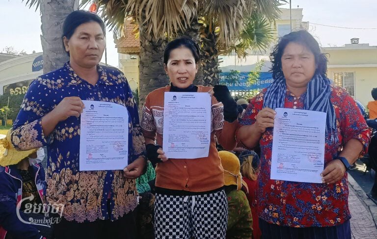 Boeung Tamok villagers show their court summons in front of Prek Pnov district hall on January 15, 2024. (CamboJA/Phon Sothyroth)