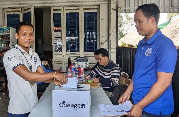 Chea Chan (left) drops his ballot paper into the box during the polls where he was later elected as a union leader at Wing Star Shoes factory on January 10, 2024. (Supplied)