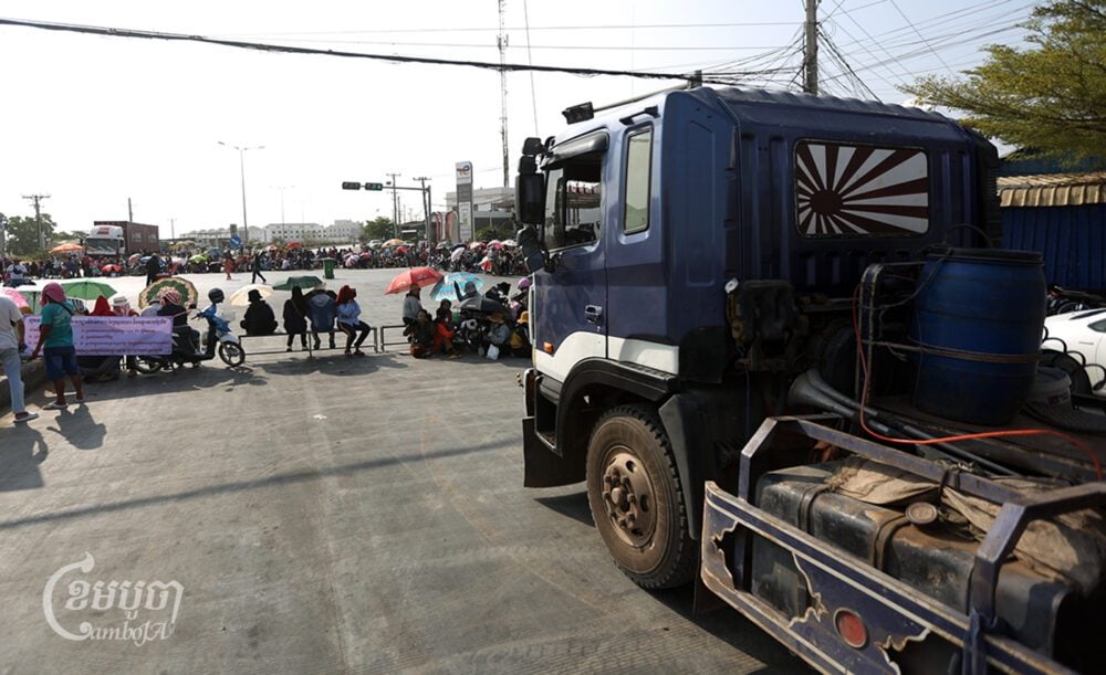 : Y&W Garment workers block the road on the outskirts of Phnom Penh as a part of their protest to demand a solution from the government, on March 22, 2024. (CamboJA/Pring Samrang)