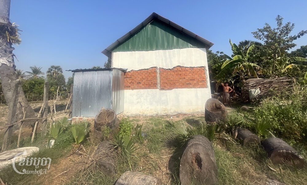 A resident restored and then tried to cover an addition to her home that was removed by Apasara Authority’’s conservation patrollers in Prasat Bakong district’s Ampil commune in Siem Reap province on February 12, 2024. (CamboJA/Khuon Narim)