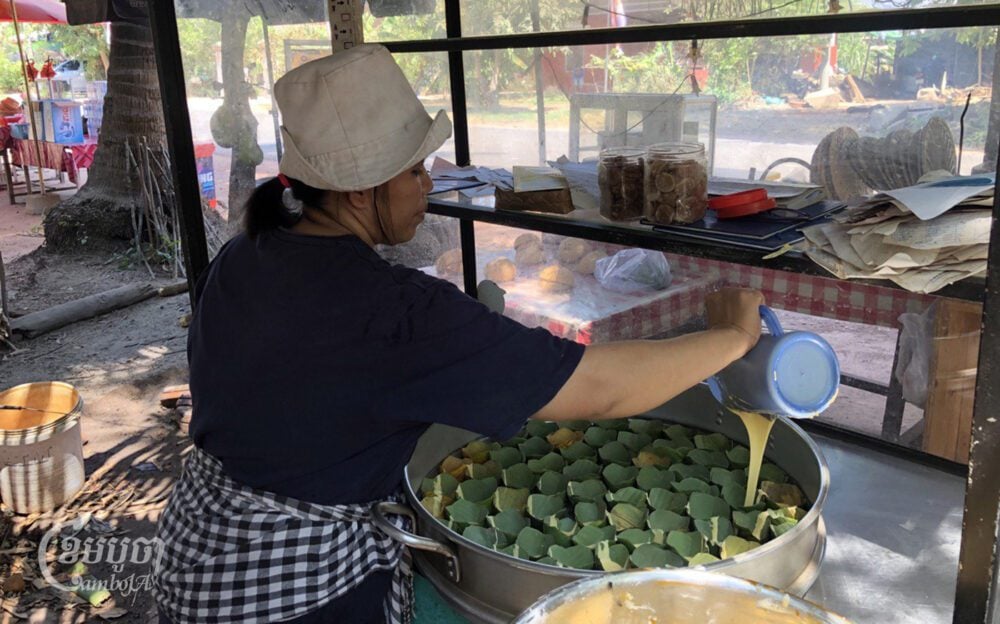 Tan Ang, a vendor in Preah Dak village, prepares steamed palm cakes on April 1, 2024. (CamboJA/ Seoung Nimol)