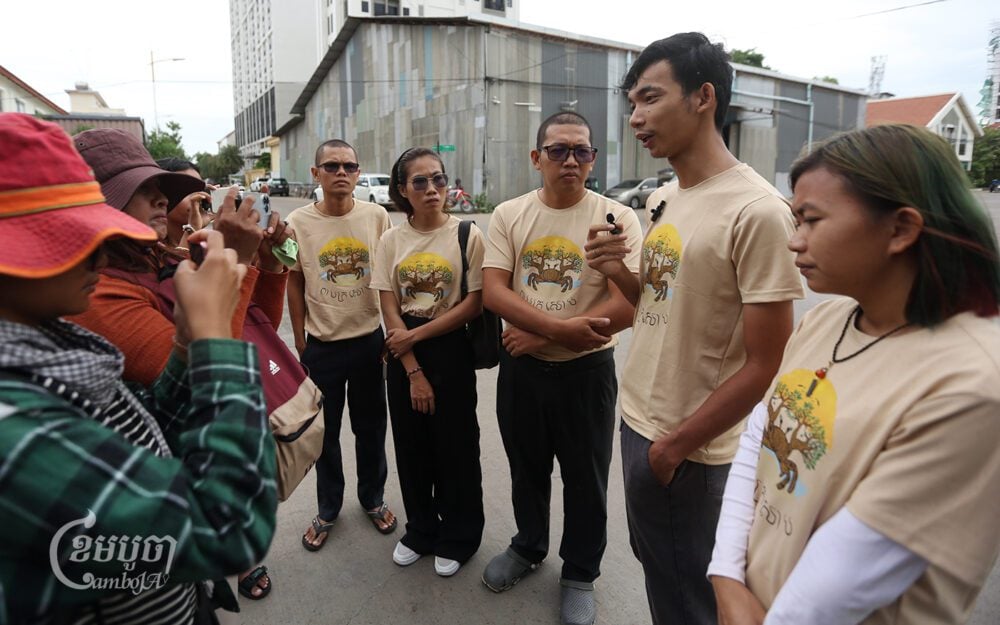 Five environmental activists speak to journalists before their hearing at the entrance of the Phnom Penh Municipal Court on June 24, 2024. (CamboJA/Pring Samrang)