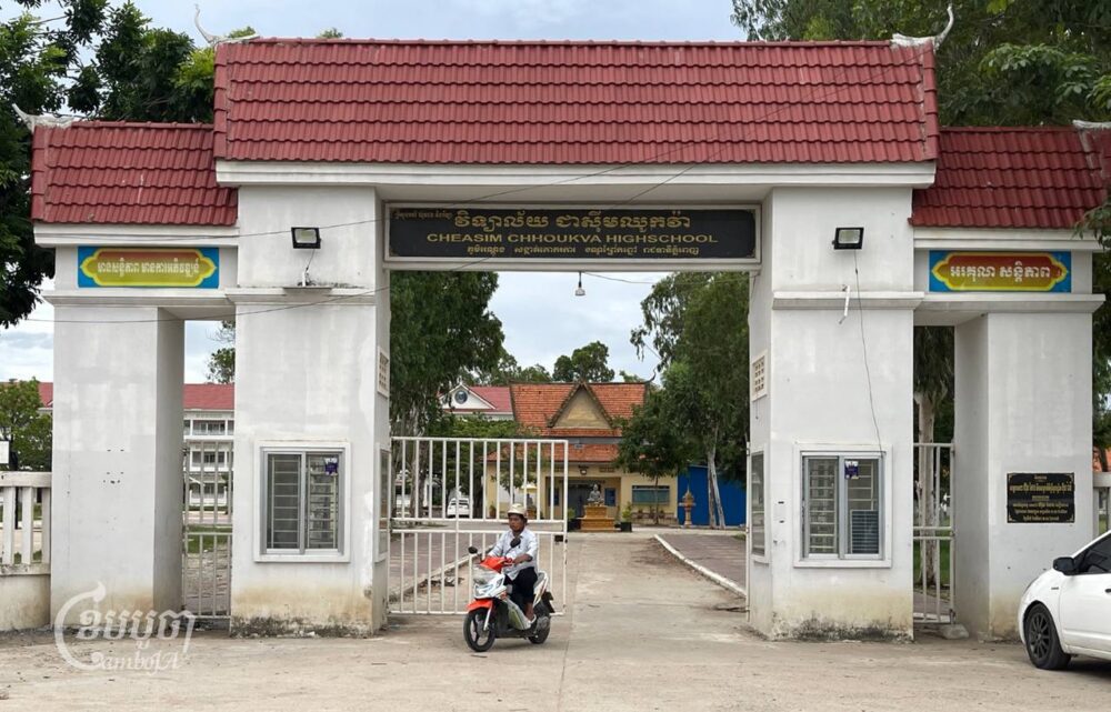 A motorist rides his motorbike out of Chhouk Va High School on July 11, 2024. (CamboJA/Pring Samrang)