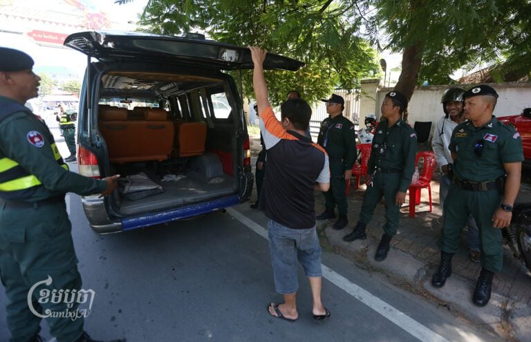 Police check vehicles entering Phnom Penh on Sunday morning on a street in Kandal province to stop any anti-CLV-DTA demonstrations planned on August 18. (CamboJA/Pring Samrang)
