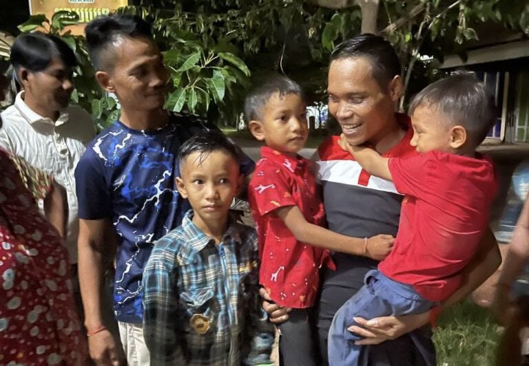 Chea Chan, Wing Star Shoes union leader, carries his sons after being released on August 19 2024. (Supplied)
