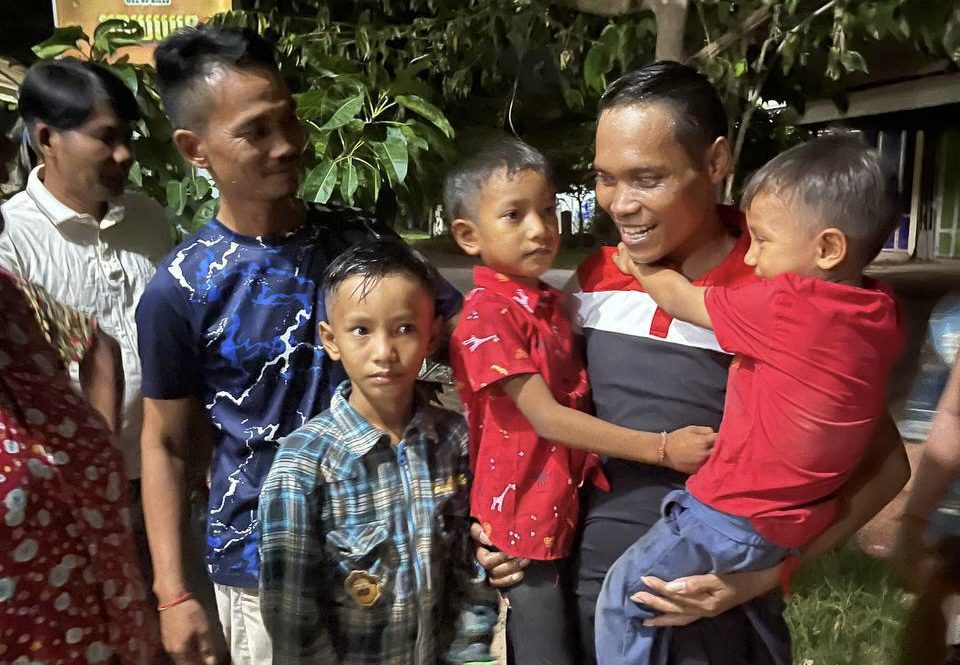 Chea Chan, Wing Star Shoes union leader, carries his sons after being released on August 19 2024. (Supplied)