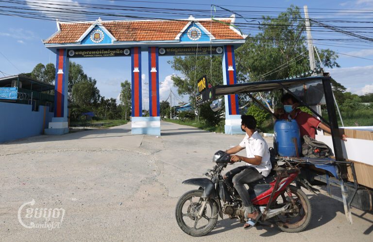 A man drives his motorcar past the Correctional Center 1 on the outskirts of Phnom Penh on November 5, 2021. (CamboJA/Pring Samrang)