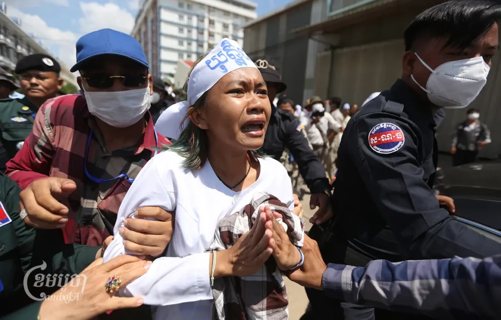 Police arrest Phuon Keoreaksmey, a Mother Nature activist, after Phnom Penh Municipal Court sentenced her to six years in prison on July 2, 2024. (CamboJA/Pring Samrang)