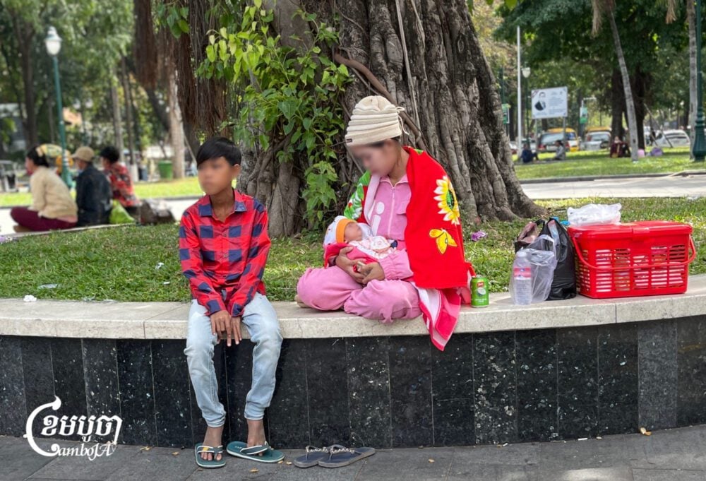 A woman carries her baby while waiting for treatment at Kantha Bopha Hospital on January 17, 2025. (CamboJA/Pring Samrang)