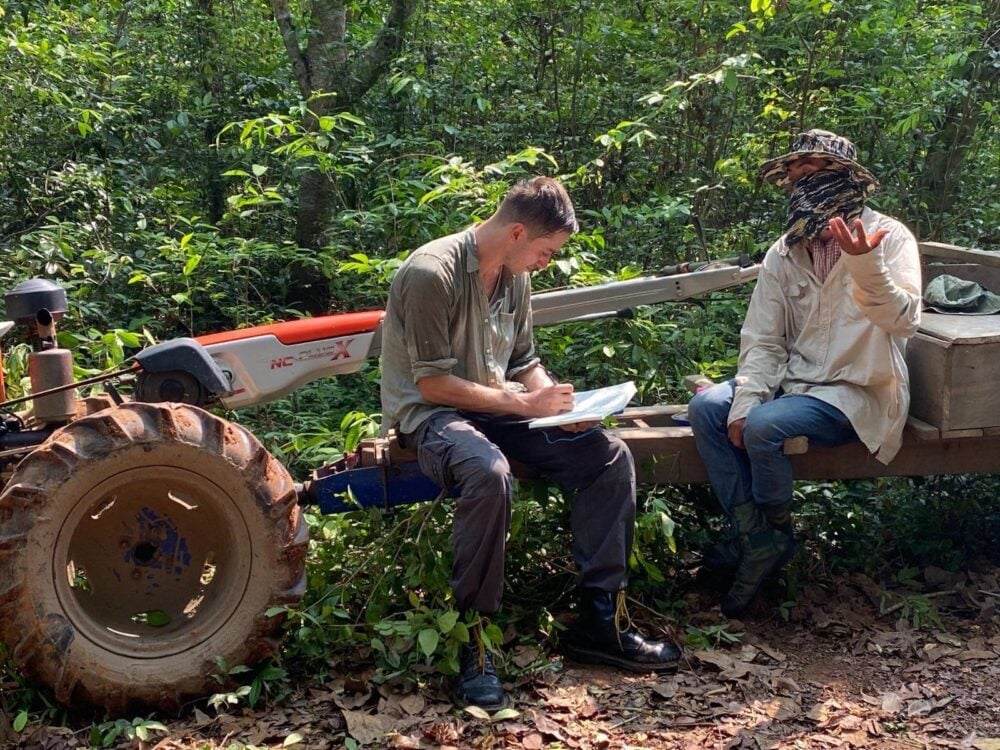 Gerald Flynn interviews community forest patrollers in Chhaeb-Preah Roka Wildlife Sanctuary while investigating illegal logging in 2023. Photo courtesy of Chasing Deforestation / Mongabay.