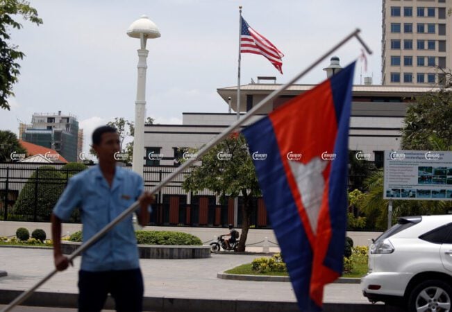 A man waves a Cambodian flag in front of the U.S. Embassy in Phnom Penh. Picture taken on April 13, 2018. (CamboJA/ Pring Samrang)