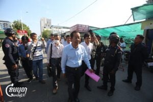 Rong Chhun, an advisor to Nation Power Party, arrives at the Phnom Penh Municipal Court for his trial on April 23, 2025. (CamboJA/Pring Samrang)