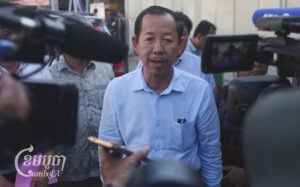 Rong Chhun, advisor to the Nation Power Party, speaks to journalists as he arrives at the Phnom Penh Municipal Court for his trial on April 23, 2025. (CamboJA/Pring Samrang)