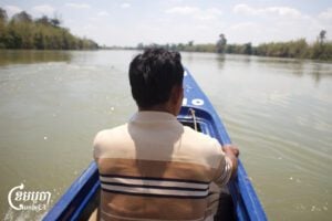 Tha Lev, a resident of Thmey village in Ratanakiri province, takes a boat along the Srepok River to visit the proposed LSP3 dam site. March 14, 2025. (CamboJA/Coby Hobbs)