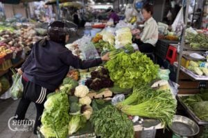 A vendor sells vegetables in a market in Phnom Penh, May 13, 2025. (CamboJA/Pring Sarang)