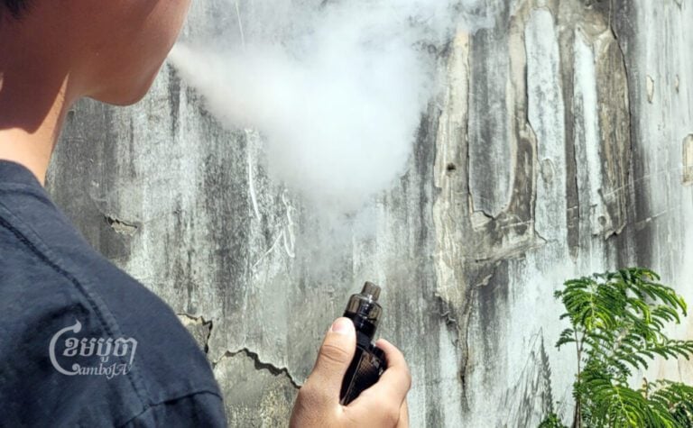 A teen vapes in Phnom Penh amid WHO calls for a ban. Photo taken in December 2022. (CamboJA/Pa Tongchen)