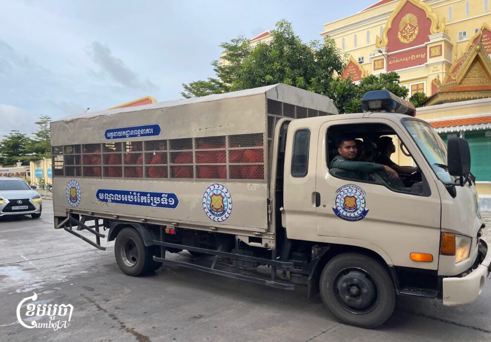 A police truck transports prisoners, including Paris Peace Agreement activists, to Phnom Penh court on July 3, 2025. (CamboJA/Pring Samrang)