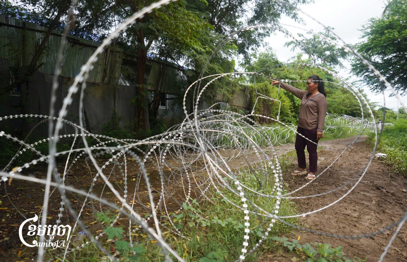 A Cambodian villager shows her house in Prey Chan village in Banteay Meanchey province where Thai soldiers evicted her family and laid razor wire around it in August 2025. (CamboJA/Yarn Soveit)