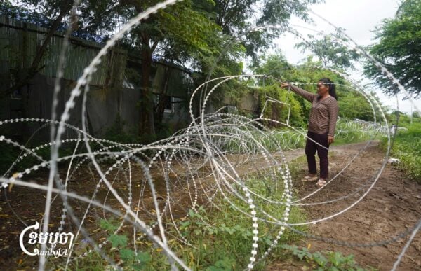 A Cambodian villager shows her house in Prey Chan village in Banteay Meanchey province where Thai soldiers evicted her family and laid razor wire around it in August 2025. (CamboJA/Yarn Soveit)