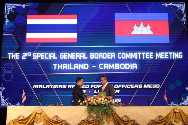 Cambodian Defense Minister Tea Seiha speaks with his Thai counterpart Nattaphon Narkphanit during border talks in Malaysia, Oct. 23, 2025. (Cambodia’s Defense Ministry/Facebook)